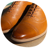 The Cap-Toe in Honey close up detail photo of broguing and leather