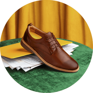 Comfortable Brown Amberjack shoes on top of a laptop