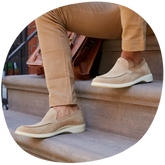 Tunda Loafers on model sitting down on stairs wearing khakis pants