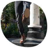 The Boot in Chestnut by Amberjack - on model jumping wearing black pants