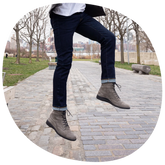 model jumping outdoors wearing jeans with The Boot in Steel Nubuck